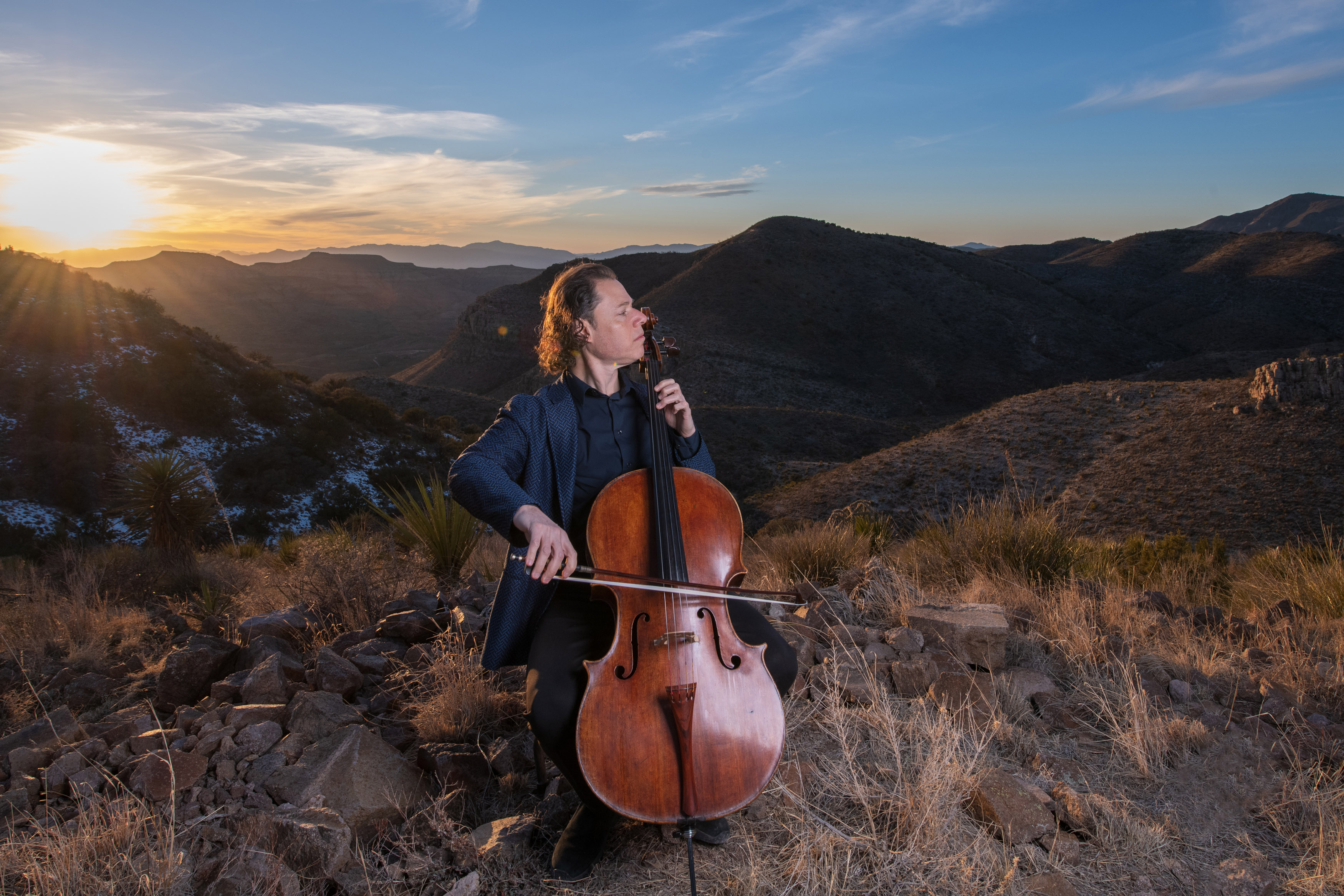 Matt Haimovitz playing Cello at sunset in a desert mountain landscape